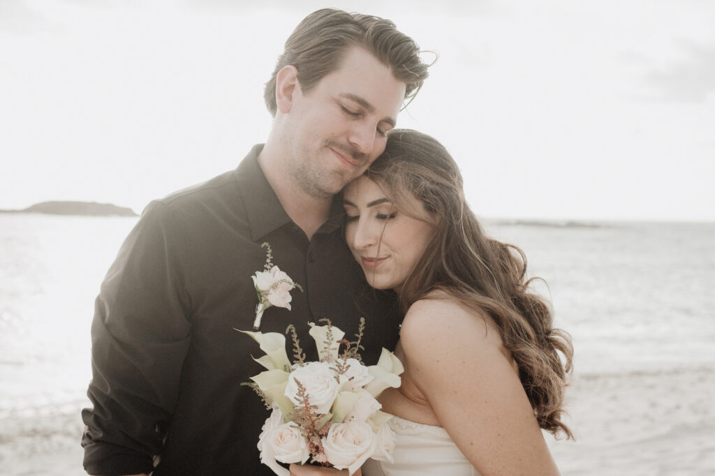 Bride and groom embrace on beach at Punta Mita elopement, St Regis resort, Mexico