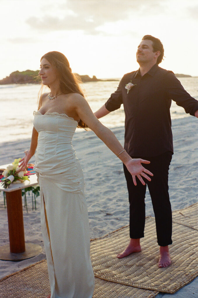 Bride and groom elopement ceremony at sunset on the beach, St Regis Punta Mita, Mexico