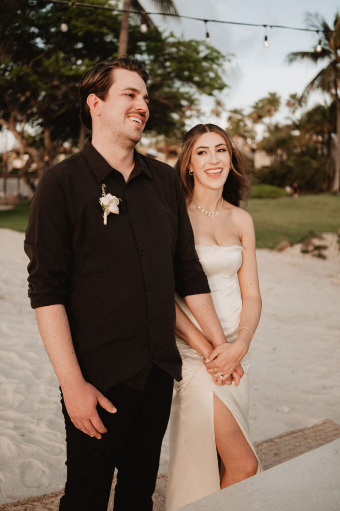 Bride and groom laughing together on sandy beach at St Regis Punta Mita elopement wedding