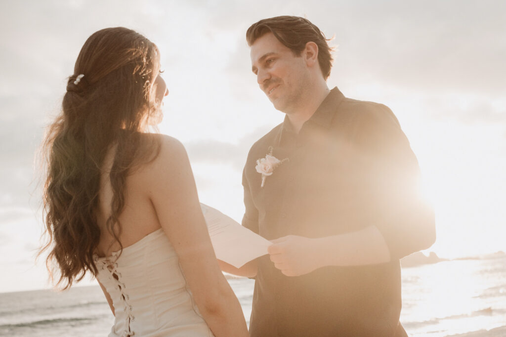 Elopement couple exchanging vows on the beach at Punta Mita, golden sunset light, St Regis Mexico