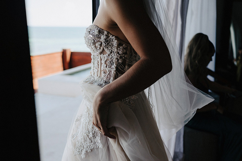 Bride in beaded strapless gown with veil, ocean view, Papaya Playa Project Tulum wedding