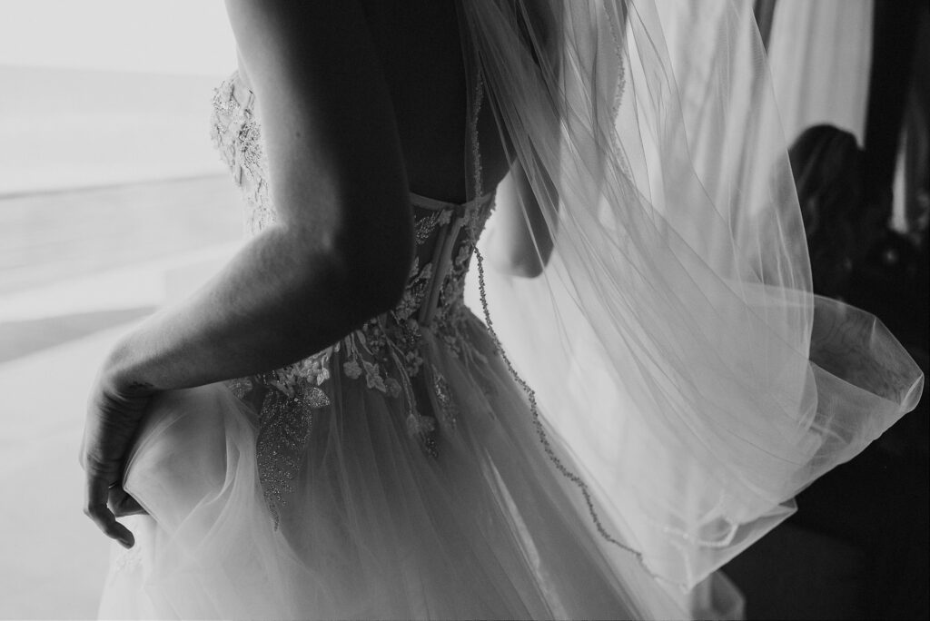 Bride in lace wedding gown and flowing veil, back detail, Papaya Playa Project Tulum wedding