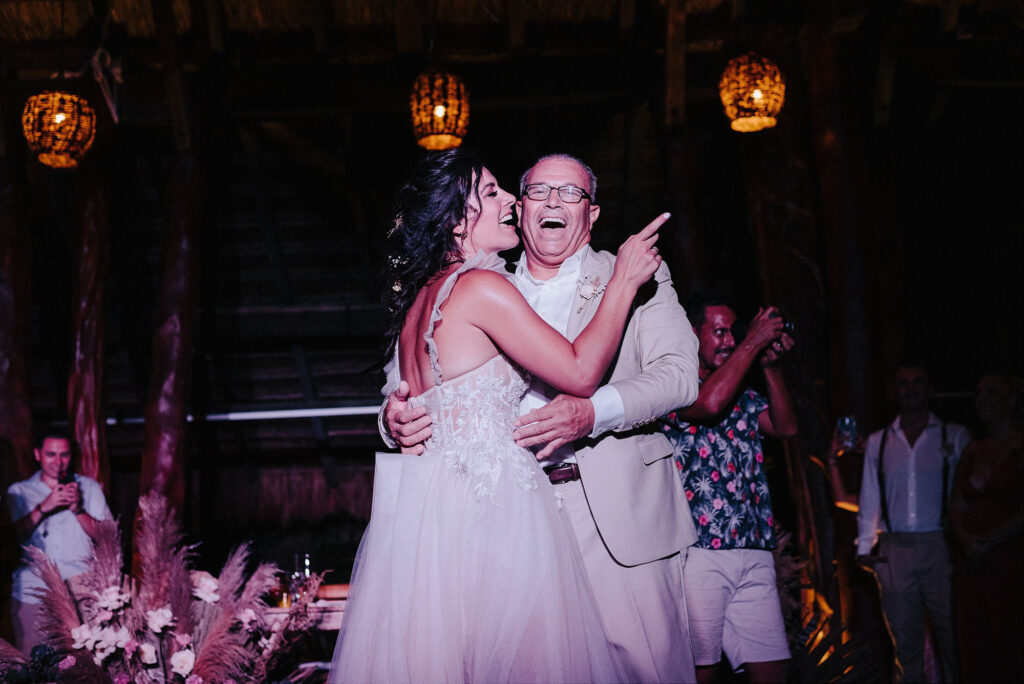 Bride and father laughing during father-daughter dance at Papaya Playa Project Tulum wedding reception