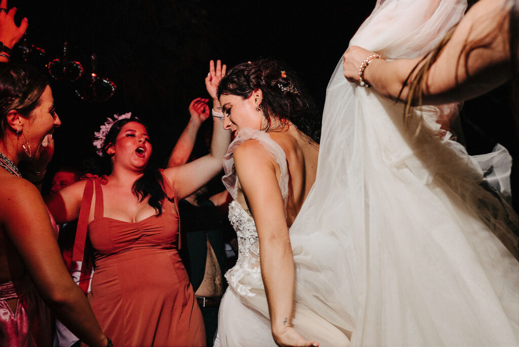 Bride dancing with guests at Papaya Playa Project Tulum wedding reception, documentary style