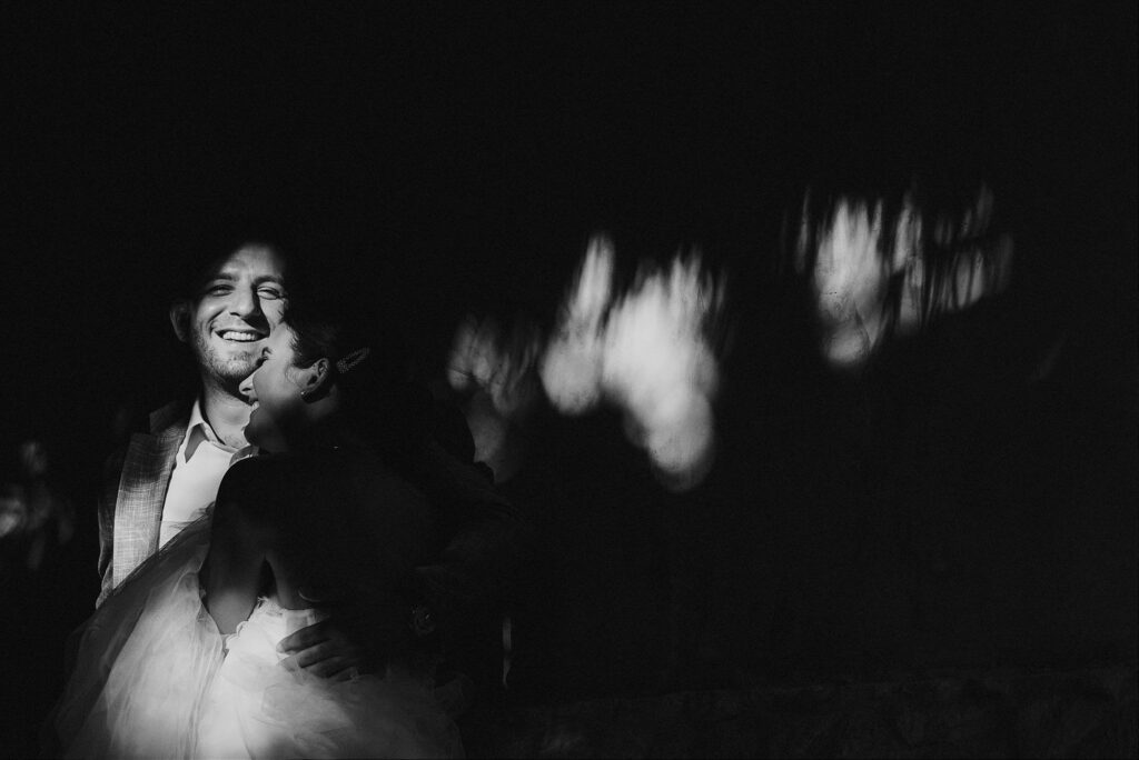 Bride and groom share a joyful moment at night, Papaya Playa Project Tulum wedding reception