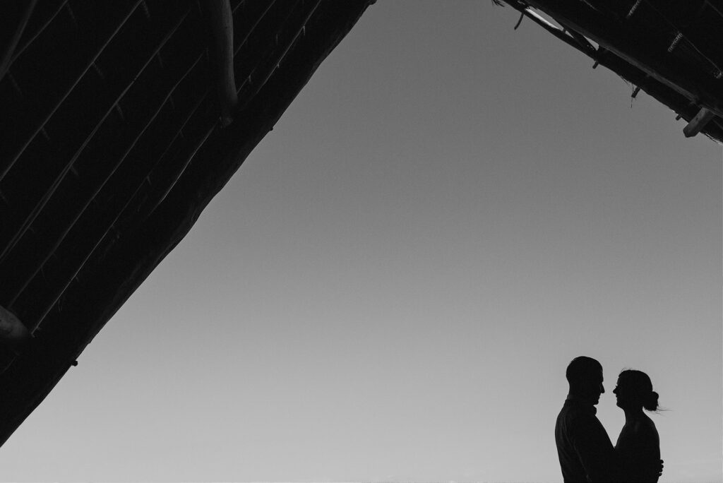 Silhouette of couple facing each other at Papaya Playa Project, Tulum wedding ceremony, black and white